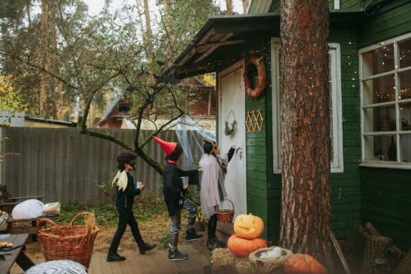 Trick or treaters approach the front door of a house