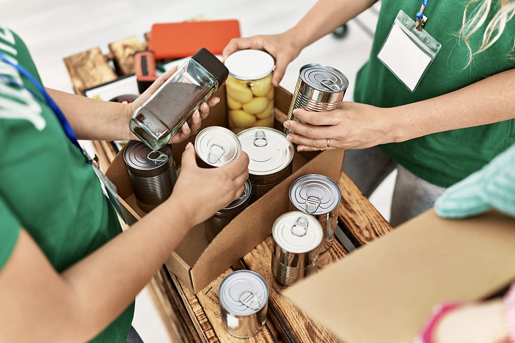Volunteers helping sort canned food for emergencies. 