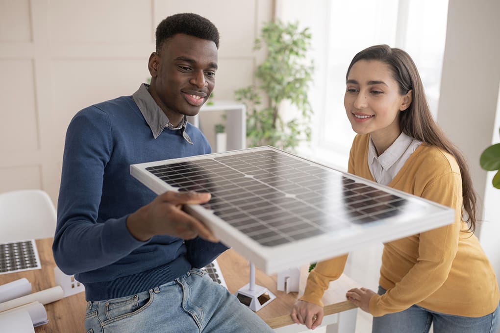 Two people inspecting a new solar panel.