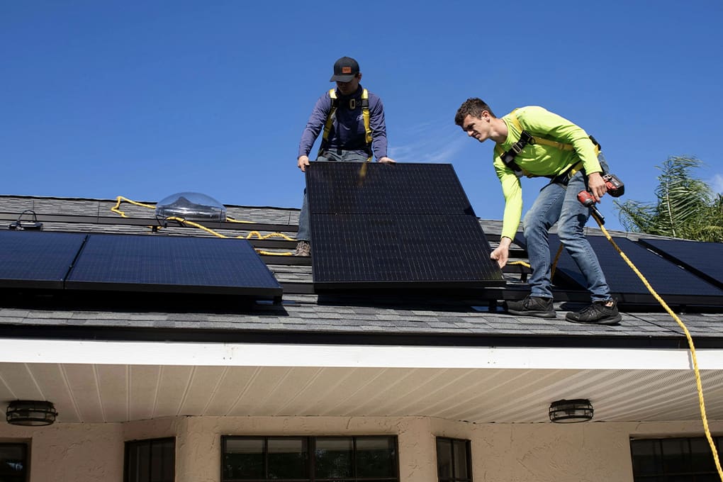 A team installing solar panels on a residential home.