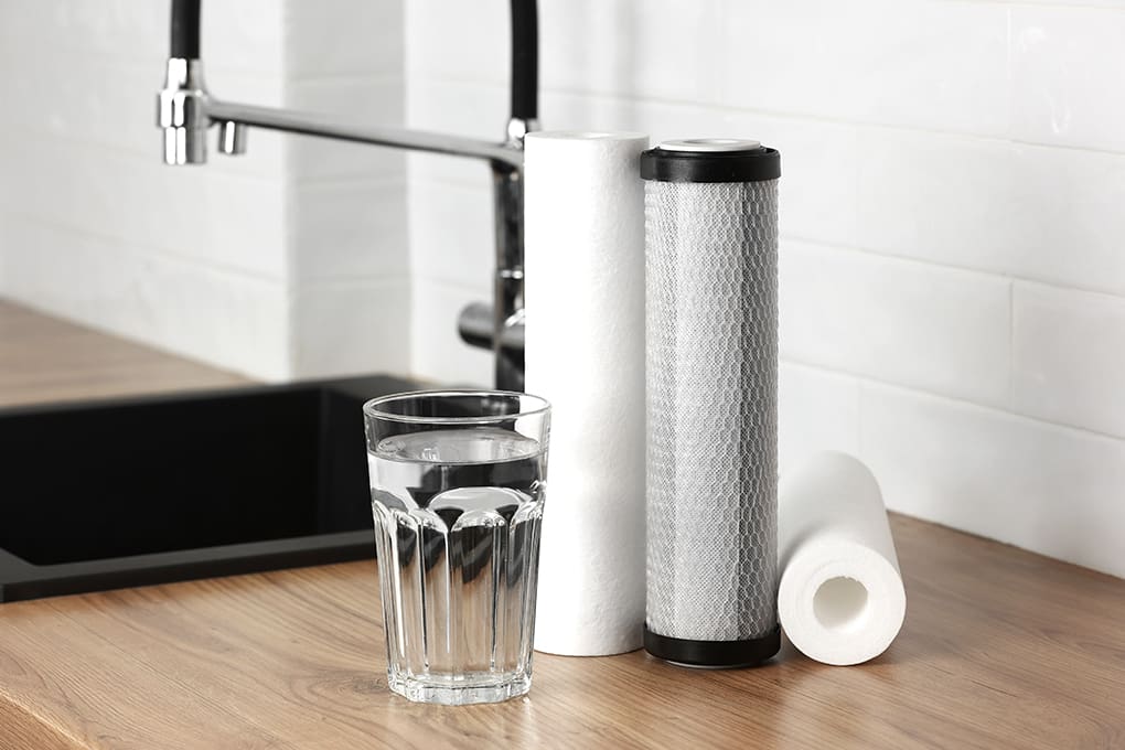 Undersink and counter top water filtration systems and a glass of water 